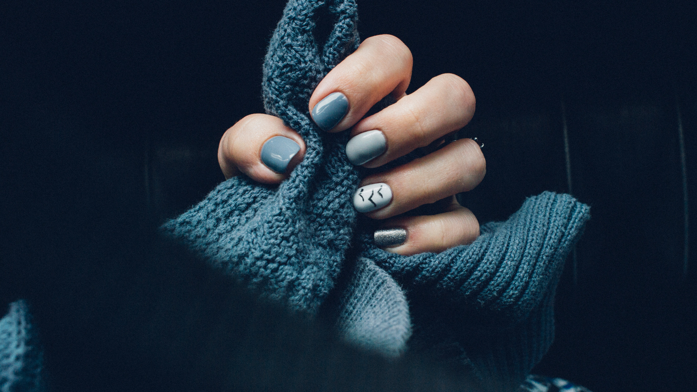 Winter manicure holding knitted jumper